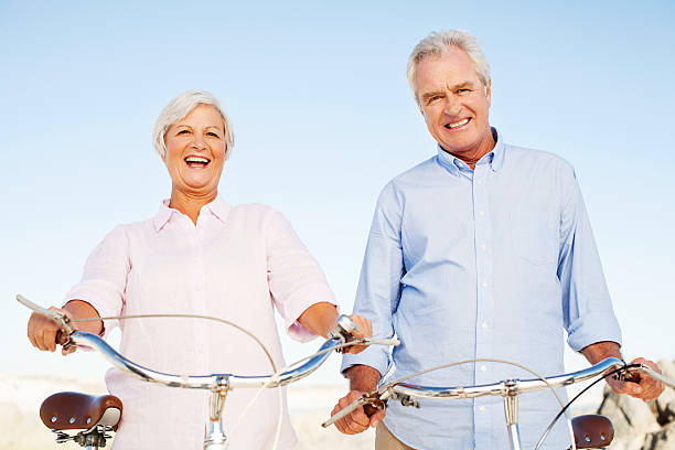 istock Active Senior Couple With Bicycles Standing Against Blue Sky 509322807