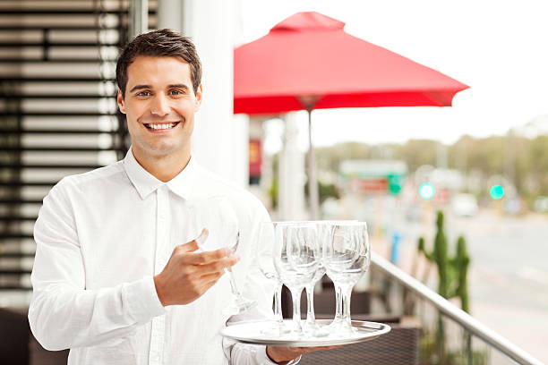 istock Waiter Holding Tray With Empty Wineglasses In Restaurant 509322867