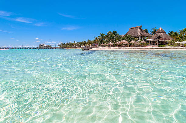 tropical sea and Playa del Norte beach in Isla Mujeres Isla Mujeres, Mexico - April 22, 2014:  day view of tropical sea and coastline on famous Playa del Norte beach in Isla Mujeres, Mexico. The island is located 8 miles northeast of Cancún in the Caribbean Sea isla mujeres stock pictures, royalty-free photos & images