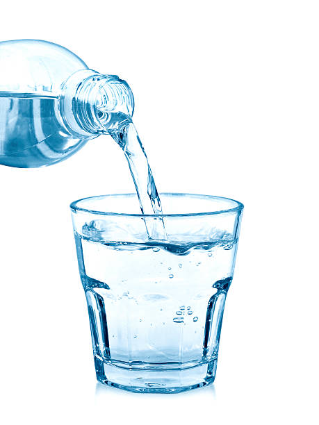 istock pouring water on a glass on white 509342234