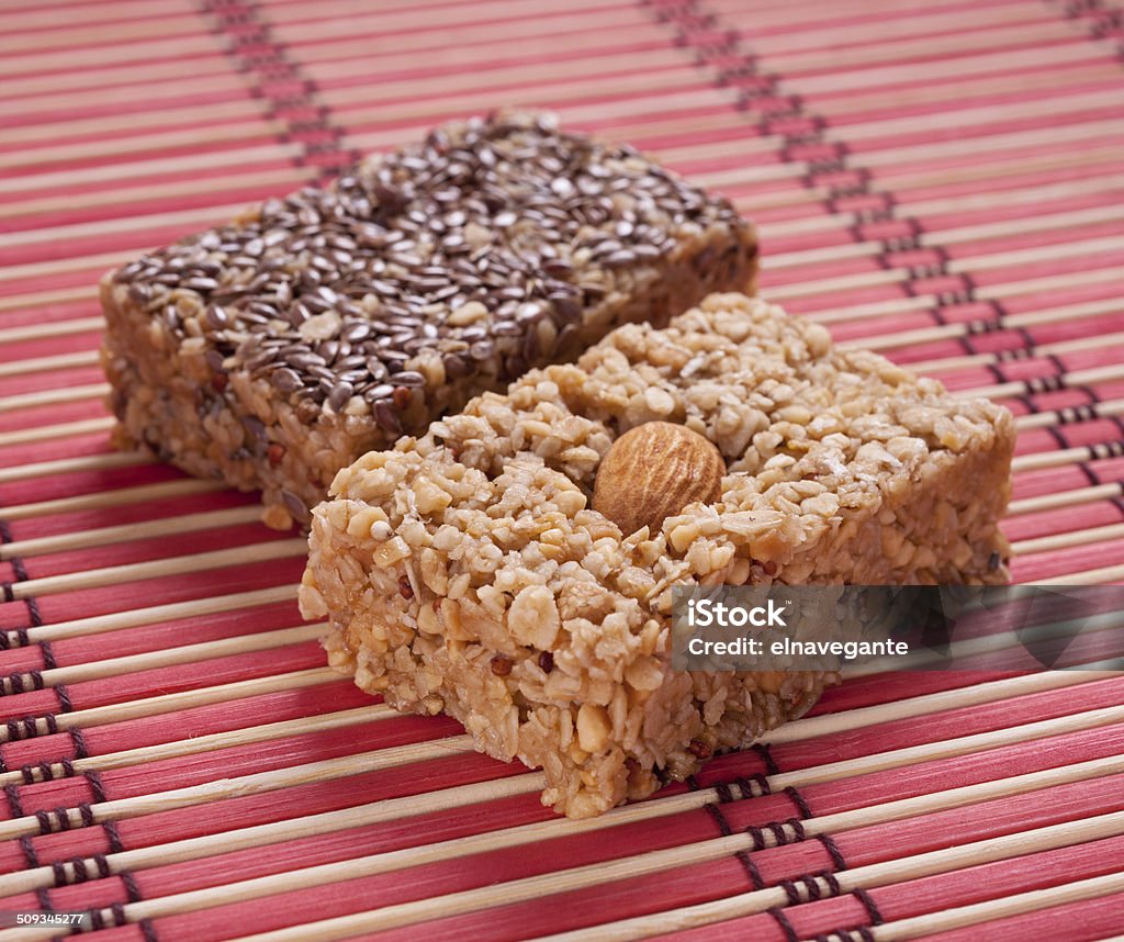 flapjack with almonds Homemade flapjack with almonds and seed on red mat. Breakfast Cereal Stock Photo