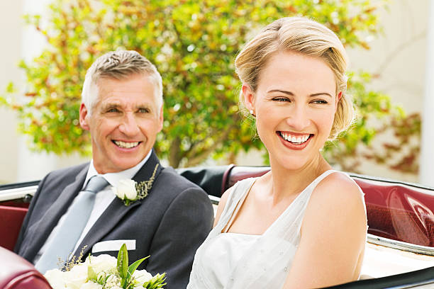 istock Bride With Father Looking Away While Sitting In Convertible 509345753