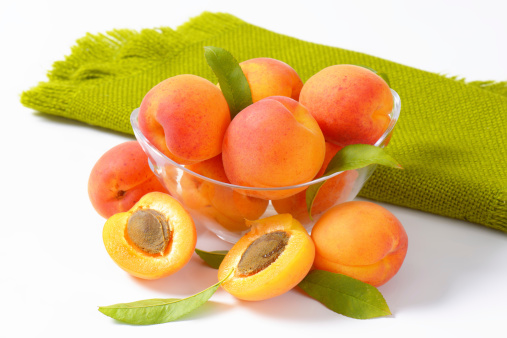 bowl of ripe apricots with leaves