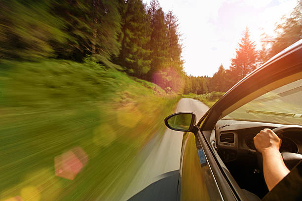 istock Driving a car through a forest on single lane road 509347254