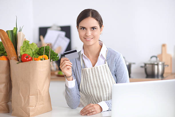 istock Smiling woman online shopping using computer and credit card in 509347808