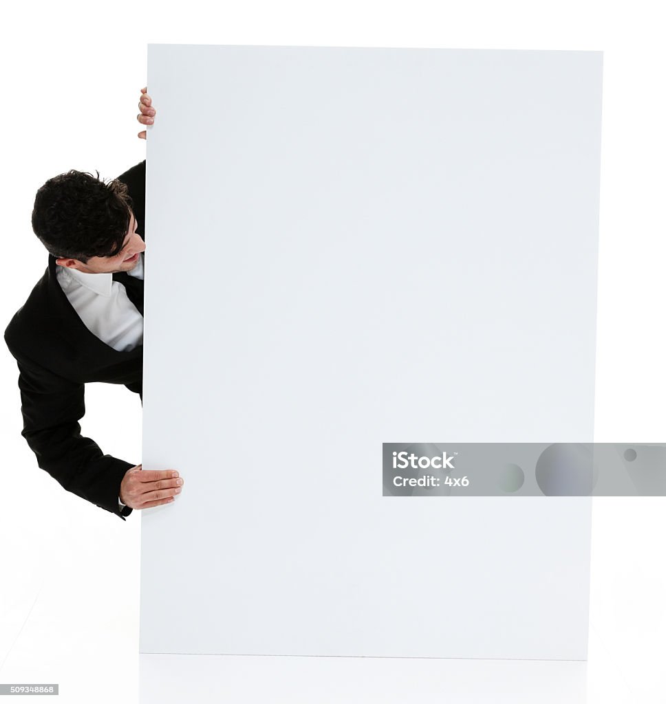 Businessman showing placard Businessman showing placardhttp://www.twodozendesign.info/i/1.png 20-24 Years Stock Photo