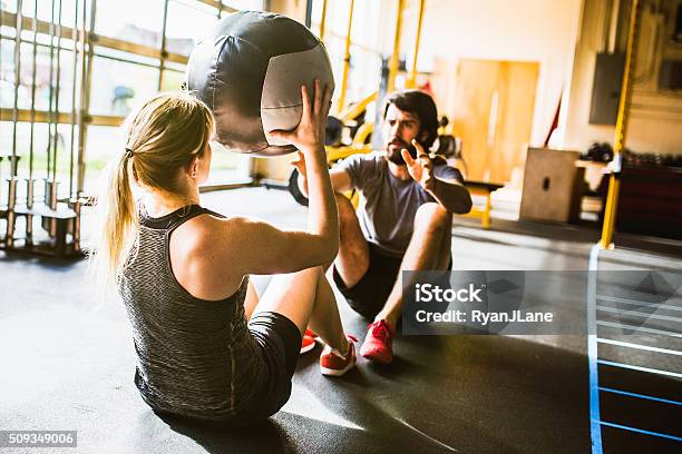 Ab Crunches With Medicine Ball Stock Photo - Download Image Now - Gym, Exercising, Couple - Relationship