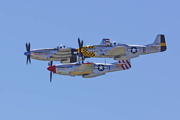 Vintage P-51 Mustang Airplane Trio Chino, California,USA- May 3,2014. Planes of Fame Airshow featuring vintage aircraft fly-overs. The 2014 Planes of Fame Airshow features 2 days of airplanes performing and many aircraft static displays. p51 mustang stock pictures, royalty-free photos & images