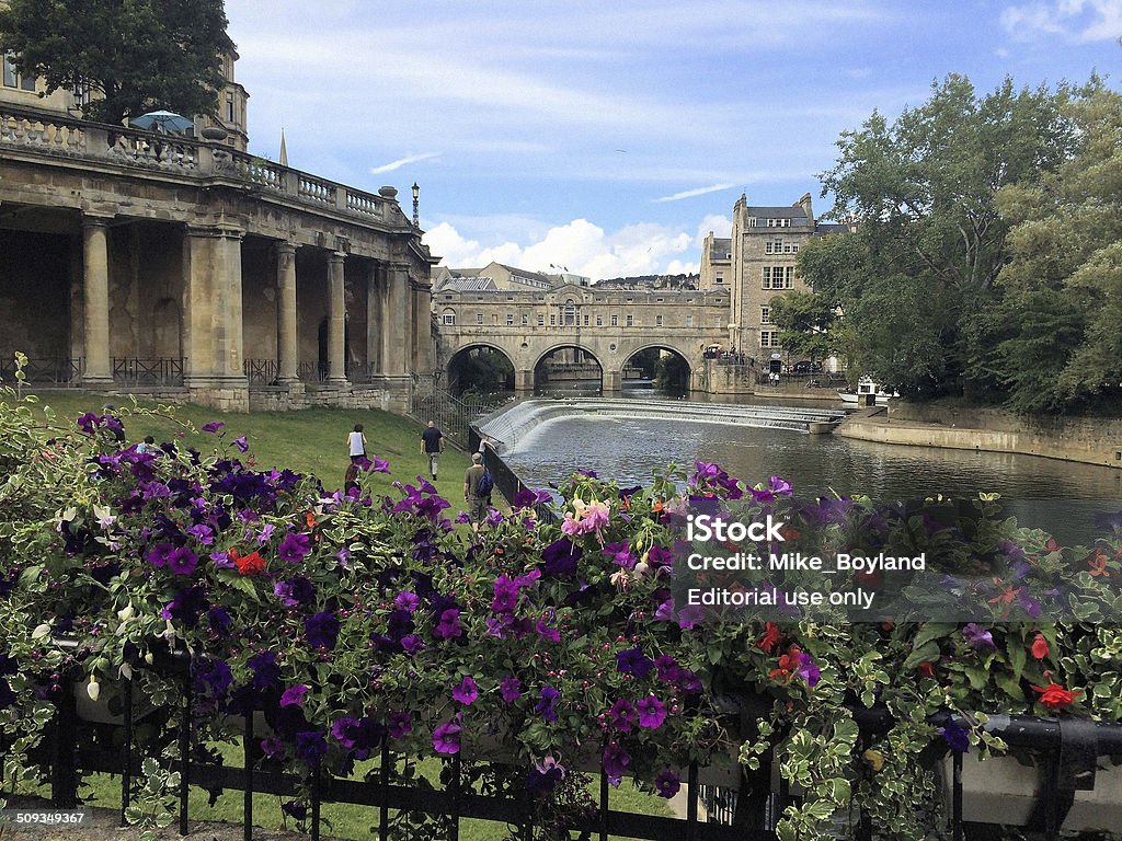 Pulteney Bridge and weir Bath, England - August 28, 2014: A view of Pulteney Bridge and weir on the River Avon in summer with tourists going about their business Bath - England Stock Photo