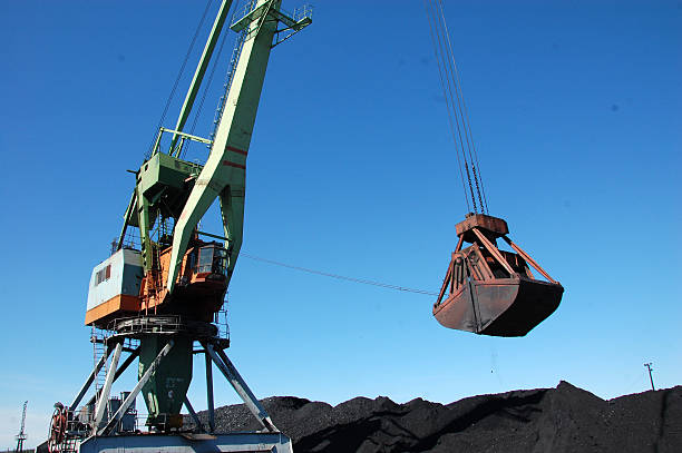 istock Dockside cargo craine loading coal at Kolyma river port 509350720