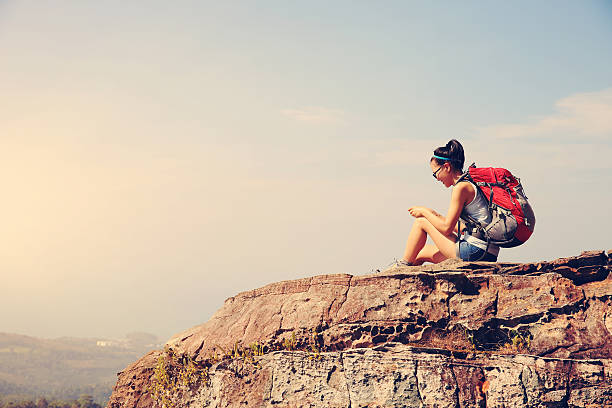istock young woman hike use smart phone at mountain peak 509350982
