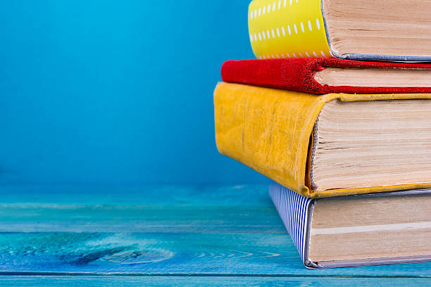 istock Stack of colorful books, grungy blue background, free copy space 509351554