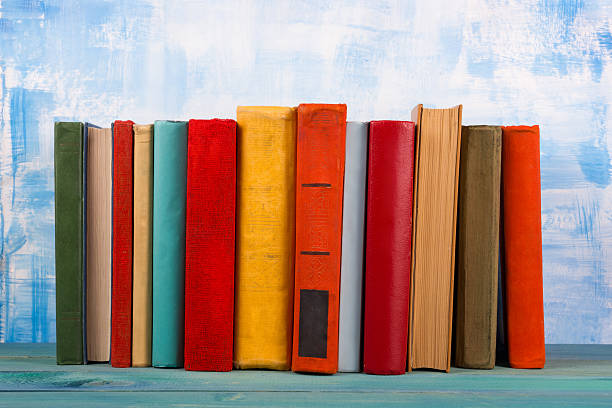 istock Composition with old vintage colorful hardback books, diary on w 509351768