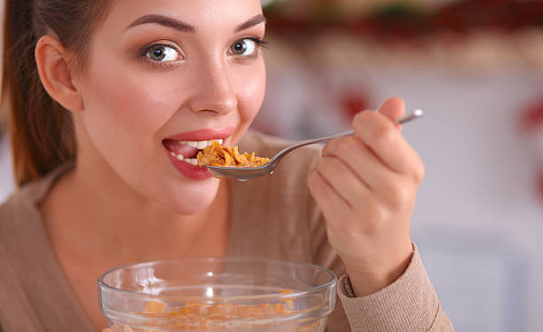 istock Happy young woman having healthy breakfast in kitchen 509352186