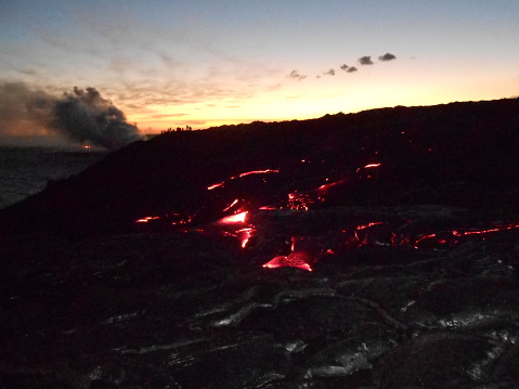 People Watching Lava Flow in Dark during Sunset on Big Island, Hawaii.
