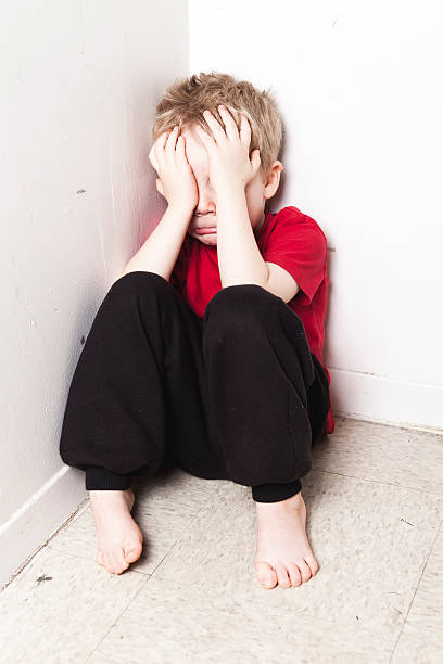 istock Neglected lonely child leaning at the wall 509352810