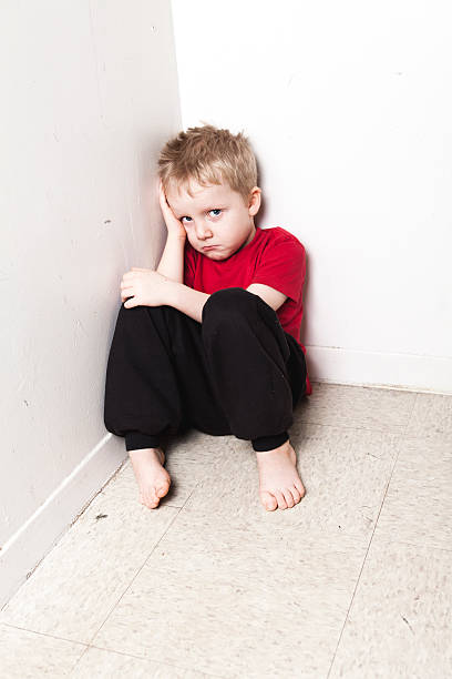 istock Neglected lonely child leaning at the wall 509352838