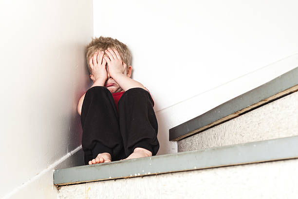 istock Neglected lonely child leaning at the wall 509352868