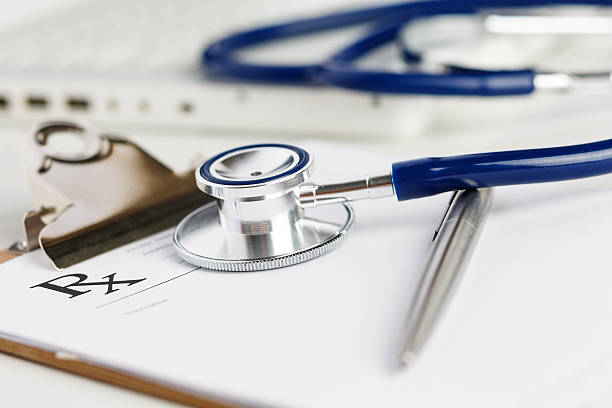 istock Prescription form lying on table with stethoscope and silver pen 509353050