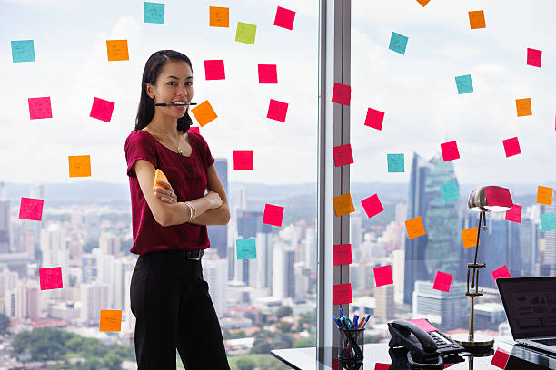 istock Portrait Business Woman Biting Pen Writing Sticky Notes 509353134