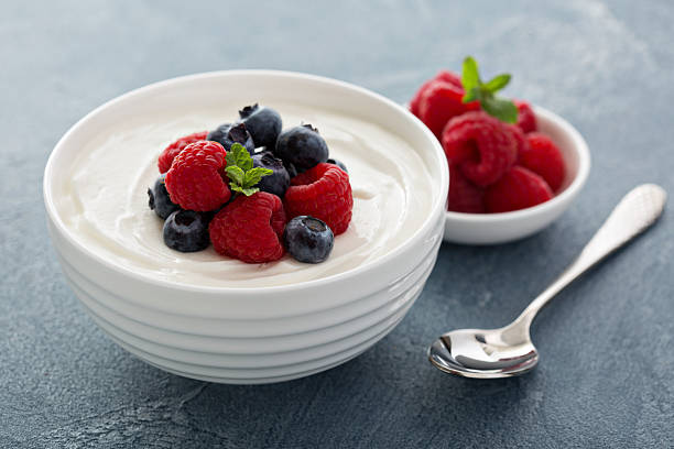 istock Natural yogurt in a bowl with berries 509353948