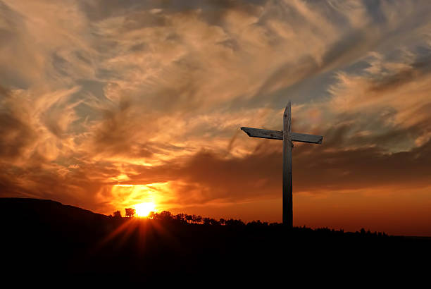 istock Christian cross over sunset background 509356022