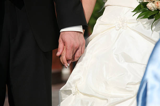 istock groom holds the bride by the hand closeup 509359194