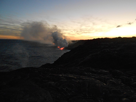 Lava Flowing into Pacific Ocean on Big Island, Hawaii during Sunset.