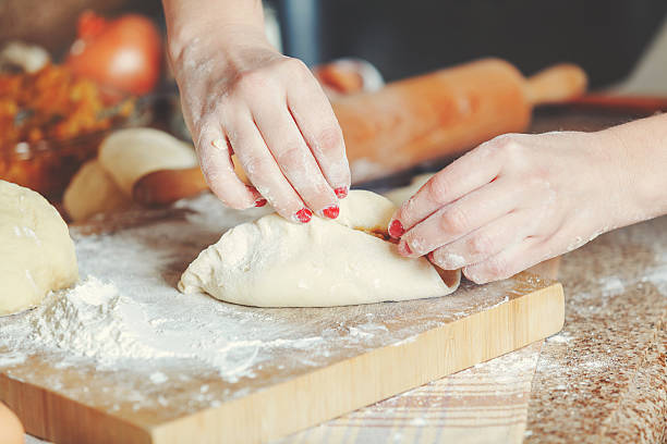 istock Female hands fasten halves patty 509360740