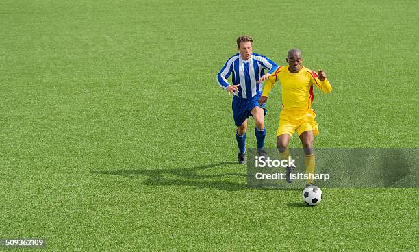 Two Soccer Players In Action Stock Photo - Download Image Now - 20-24 Years, 25-29 Years, Activity