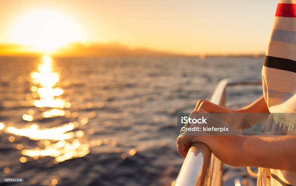 Summer getaway Closeup of female hands on a yacht during sunset.   Nautical Vessel Stock Photo