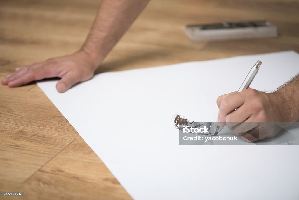 Painter and his art Painter drawing on the whatman with the lead pencil on the floor Abstract Stock Photo