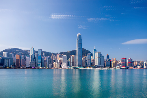 Hong Kong, China - May 1, 2018: Hong Kong skyline cityscape downtown skyscrapers over Victoria Harbour on sunset. Hong Kong, China