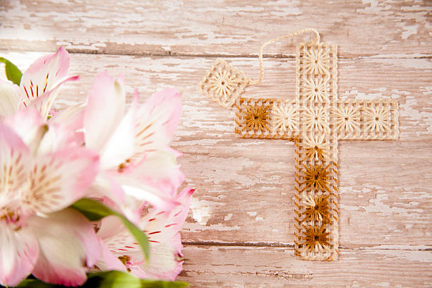 Woman hand holding a cross necklace.