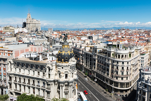 Madrid, Spain - July 6, 2014: Aerial view of Gran Vía and Madrid's skyline on a Summer early morning, with the Metropolis building to be recognized in the foreground. Some other landmarks like the Telefonica skyscraper and Faro de Moncloa are also to be recognised.