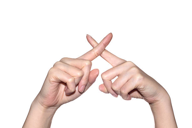 Woman hand making sign crossing fingers forming an x. Isolated on white background