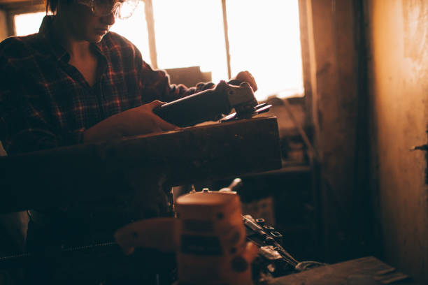 istock Young repairwoman using a grinder 509370226