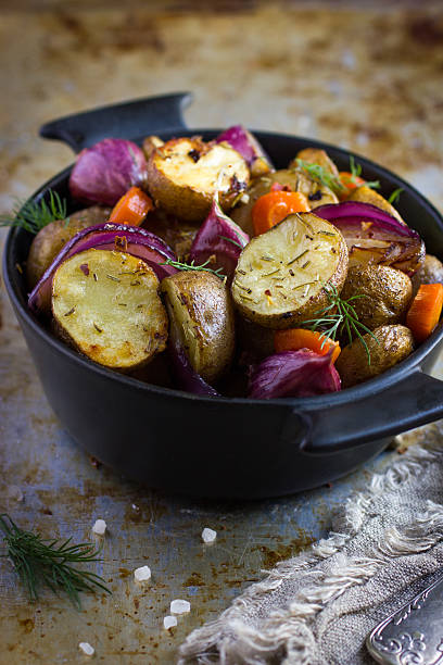istock roasted potatoes with  onions, carrot and garlic 509370244