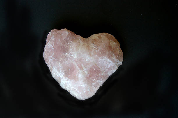 istock Pink gemstone in heart shape on black background 509370990