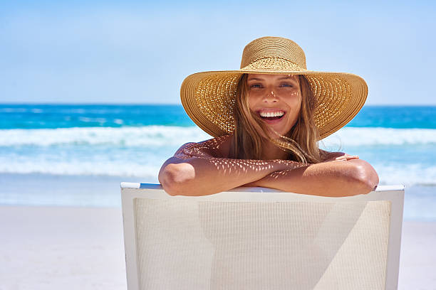 Let the summering begin! Portrait of an attractive young woman enjoying a vacation at the beachhttp://195.154.178.81/DATA/i_collage/pi/shoots/806340.jpg sun hat stock pictures, royalty-free photos & images