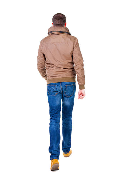 istock Back view of going  handsome man in jeans and jacket. 509390793