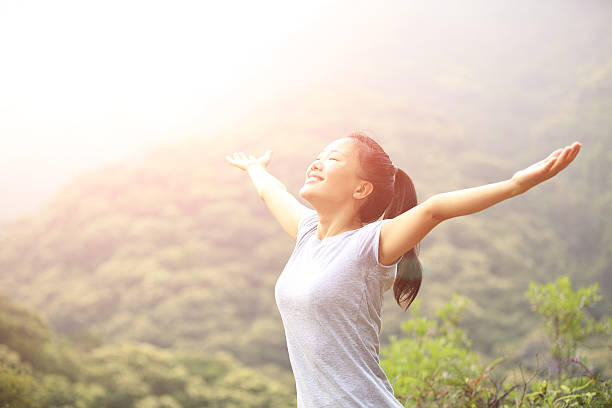 istock cheering hiking woman open arms at mountain peak 509391787