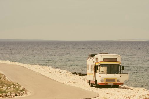 Retro van by the sea on the old photo style