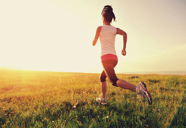 istock Runner athlete running on sunrise/sunset grass field 509395655
