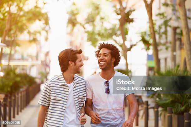 Male Friends Walking Outdoors Stock Photo - Download Image Now - Friendship, Two People, Walking