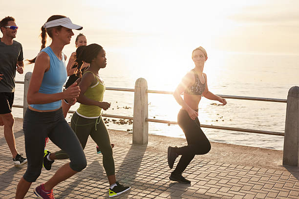 istock Young people running along seaside at sunset 509406966