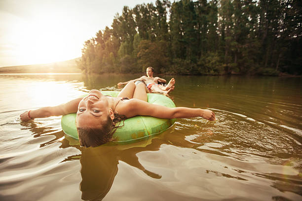 istock Young woman in lake on inflatable rings. 509408244