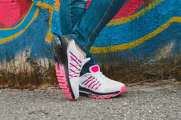 istock White and pink sneakers on girl legs 509408788