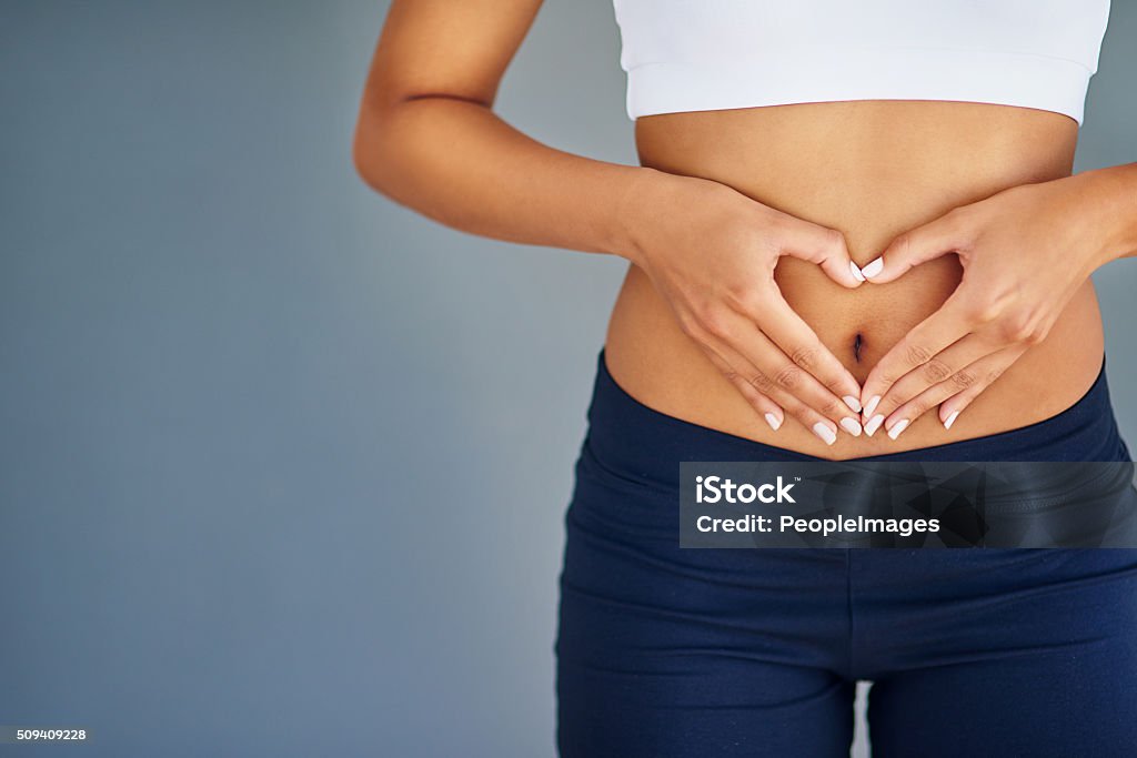 Your body deserves the best Cropped shot of a young woman making a heart shape on her stomachhttp://195.154.178.81/DATA/i_collage/pi/shoots/806339.jpg Abdomen Stock Photo