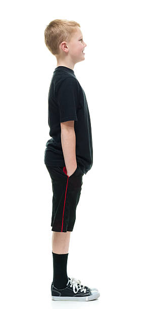 istock Smiling little boy standing and looking away 509410950